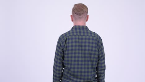 rear view of mature hipster man with blond hair