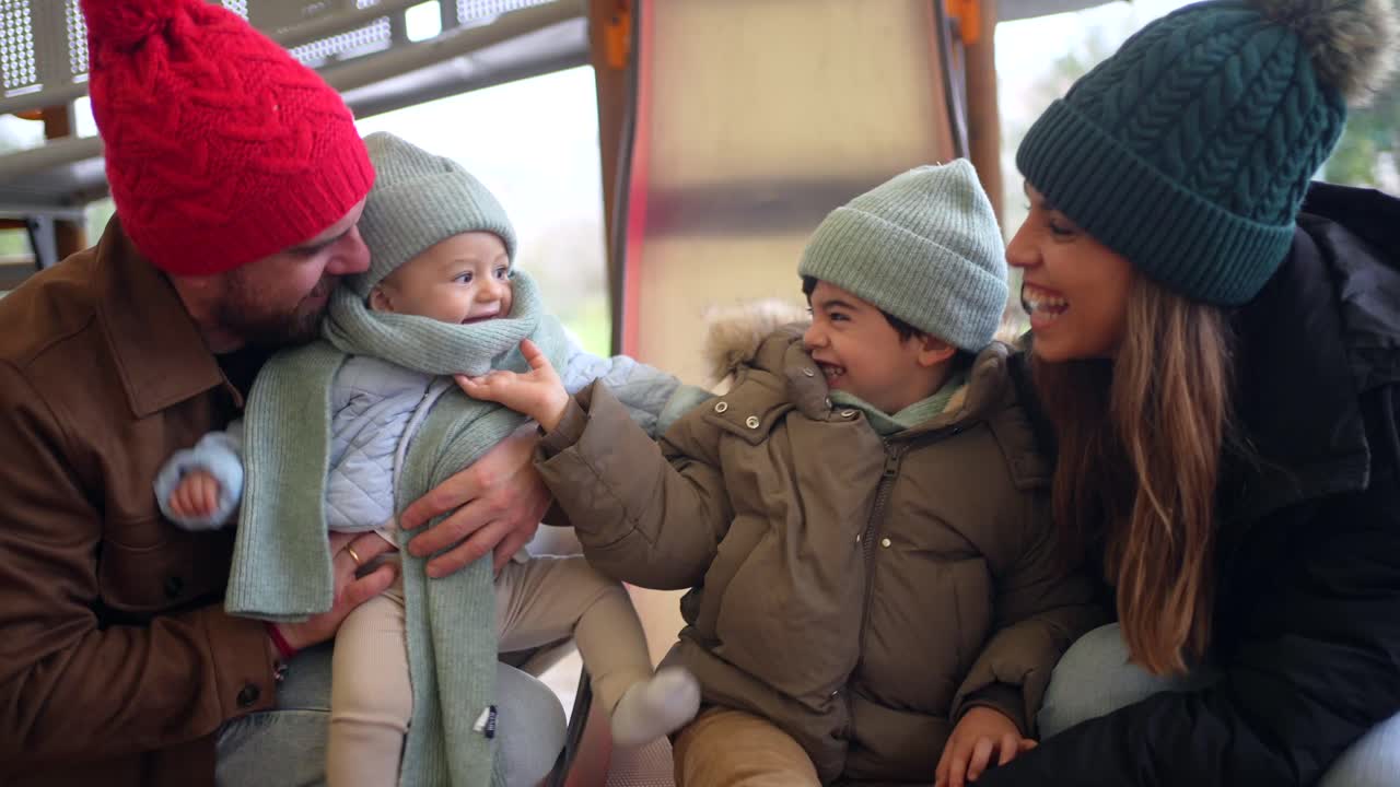 A family enjoying a day at the playground in winter