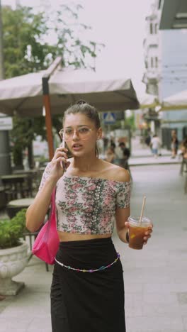 teenage girl talking on phone in city street