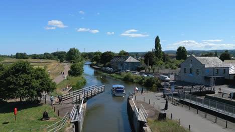 a boat passing through the river exe swing bridge and onto exeter canal, devon