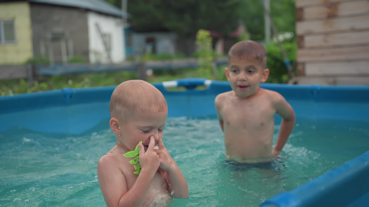 Youngsters Have Fun With Water Toys Outside, Children Giggling And Splashing In Sunny Backyard Pool, Children Laughing And Making Big Splashes As They Enjoy Summer Water Fun Outside