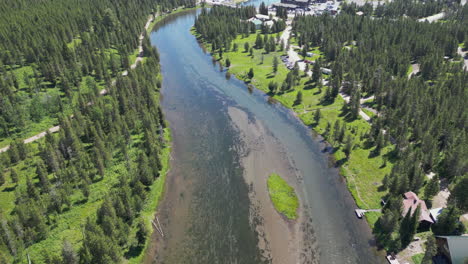 small river front town in the middle of evergreen forest