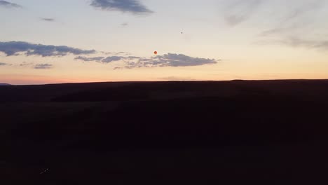 Wide-drone-shot-tracking-sky-lanterns-over-moorland-on-the-Isle-of-Lewis