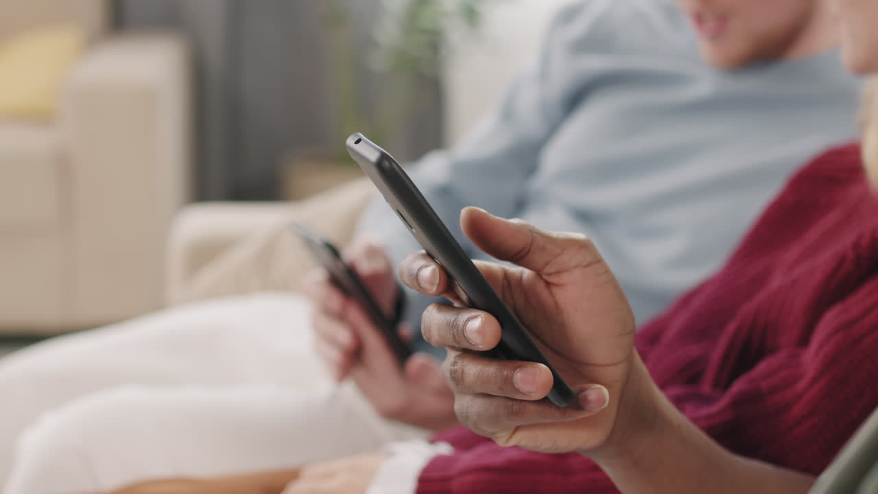 Close Up of Young People Using Mobile Phones