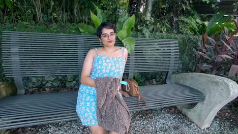 A-beautiful-Malaysian-Indian-lady-sitting-on-a-bench-in-the-middle-of-a-garden