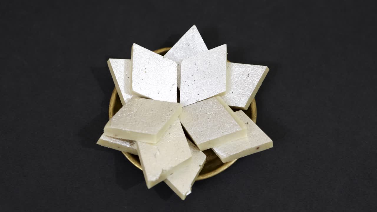 indian traditional sweet Diamond Shaped Cashew Fudge or kaju katli In a Bowl at indoor