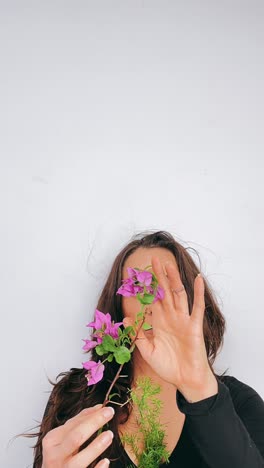 woman holding bougainvillea flowers