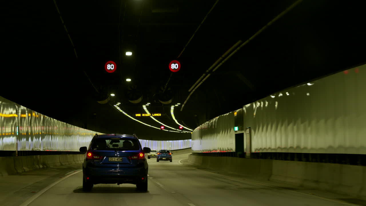 POV car Driving through a long tunnel, Sydney Australia