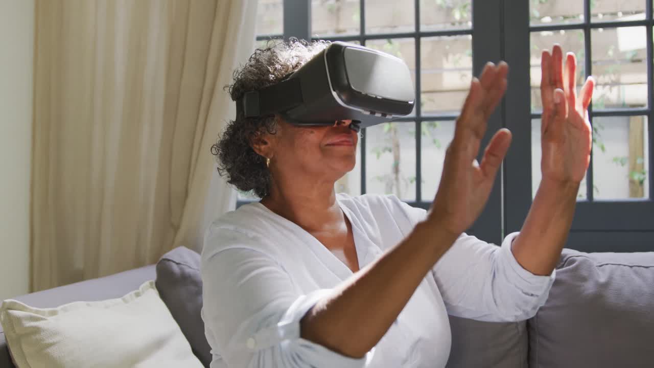Senior mixed race woman wearing a vr headset. Social distancing and self isolation in quarantine