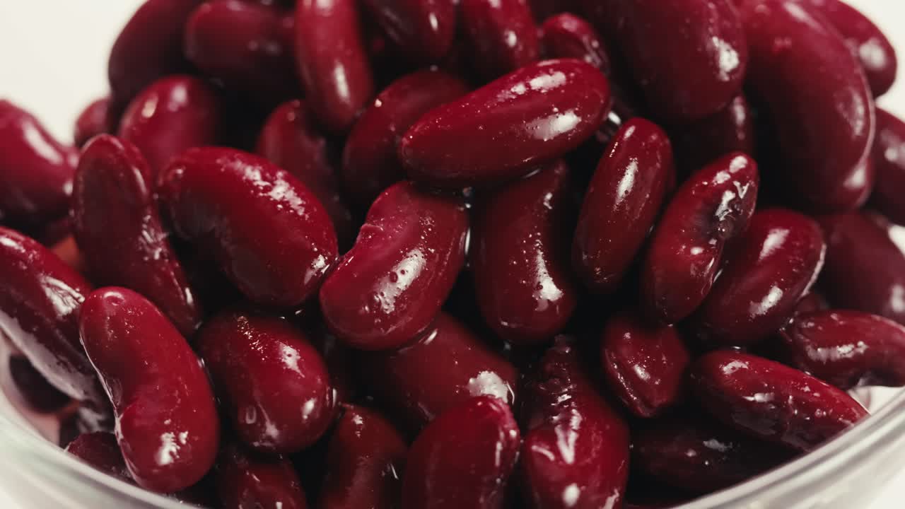 Canned red bans preserved beans rotating background close up side view. Organic steamed beans. Pickled bean for a Mexican dish