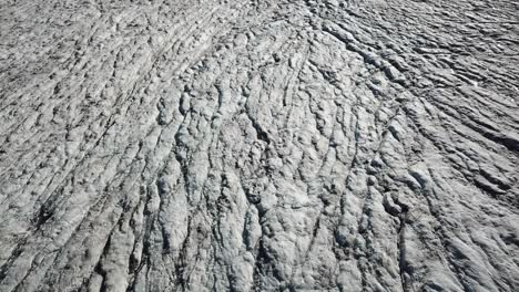 Tilt-up,-drone-shot-of-a-glacier-in-the-swiss-alps,-Orny