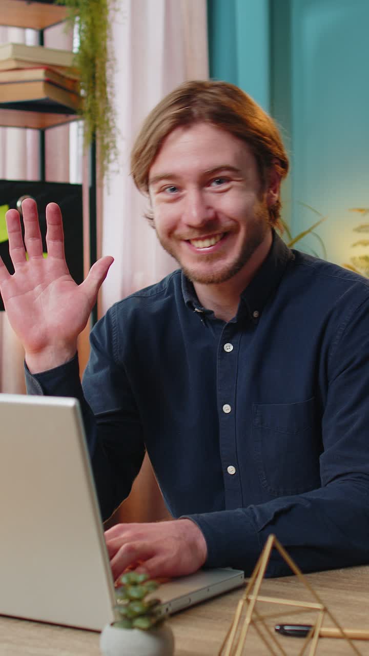 Businessman employee waves hand hello gesture greeting welcomes someone online webinar conversation