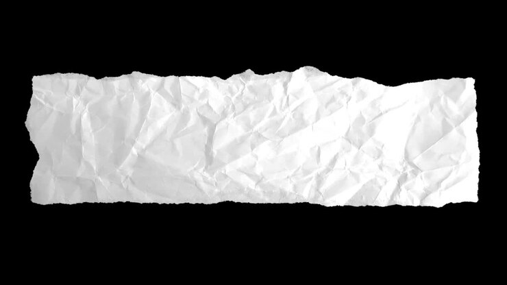Torn and crumpled white paper on a black background