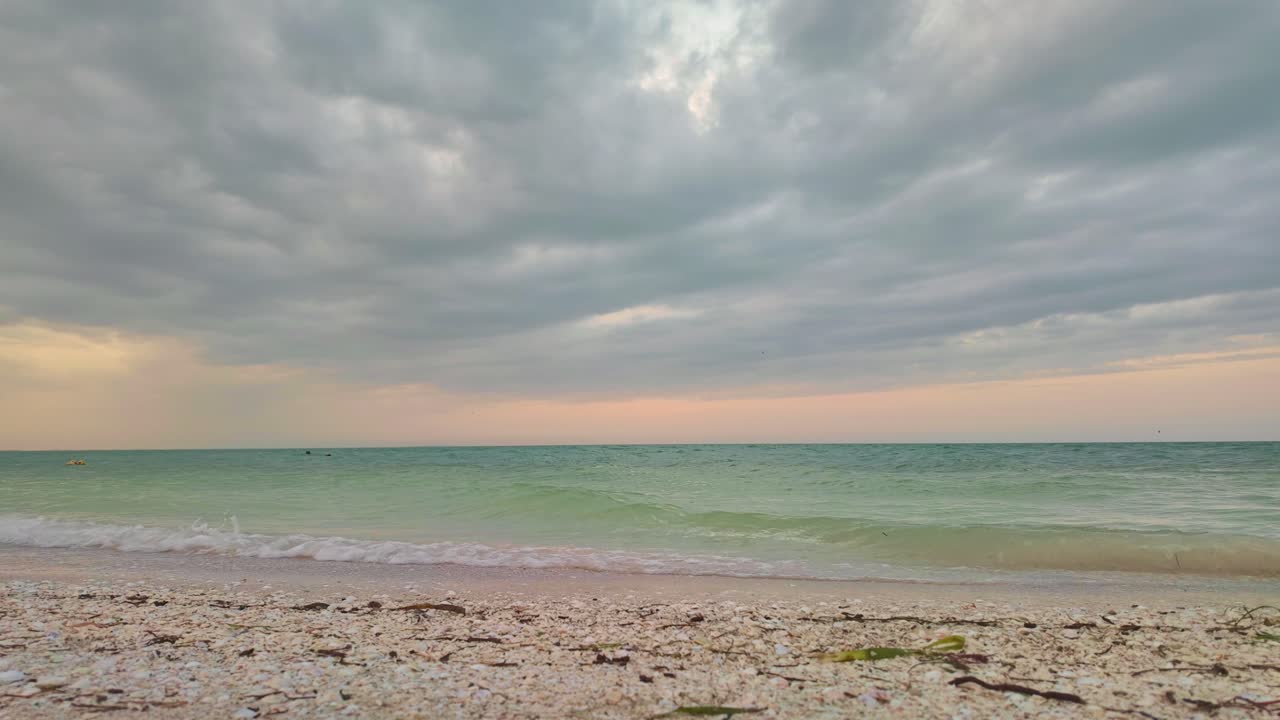 Calm beach scene with soft waves, cloudy sky, Holbox Punta Cocos Mexico