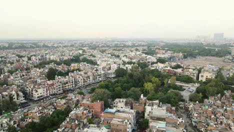 4k aerial shots of new delhi residential suburbs on a beautiful day gliding over rooftops, streets, parks and markets in india