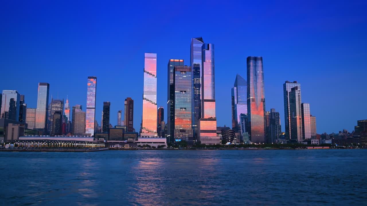 New York, USA, 1 August 2025: Buildings of New York in the light of sunset. View on the city skyline from the riverscape at dusk time
