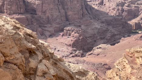 standing on a cliff overlooking petra, jordan