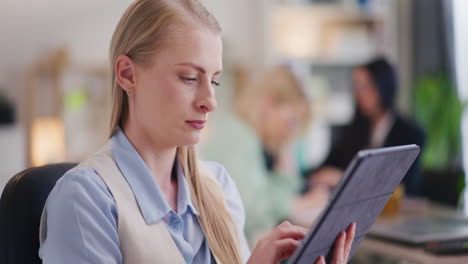 close-up of woman testing app on digital tablet