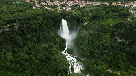 Aerial-View-Of-Marmore-Falls,-Green-Forest-With-Marmore-Village-In-Terni,-Umbria,-Italy