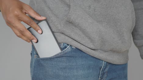 person putting phone in pocket