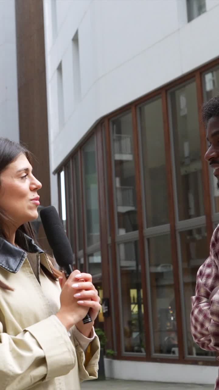 Woman Reporter Interviews Man on City Street