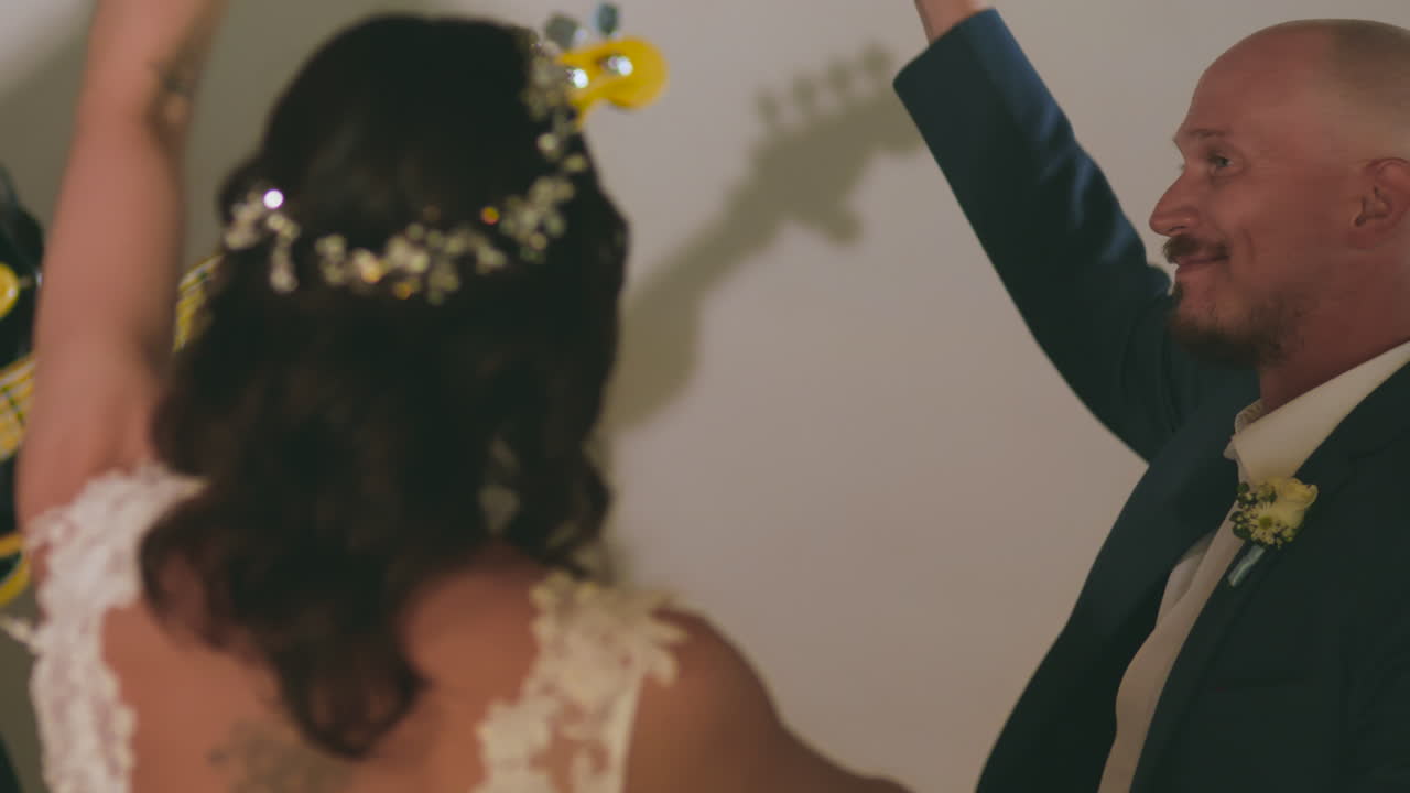 Clip of a wedding where the newlyweds dance happily with their guests.