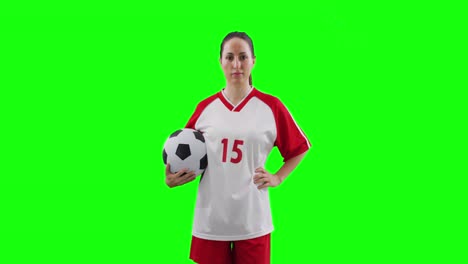 Video-of-caucasian-female-football-player-holding-football-and-copy-space-on-green-screen