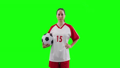 video of caucasian female football player holding football and copy space on green screen