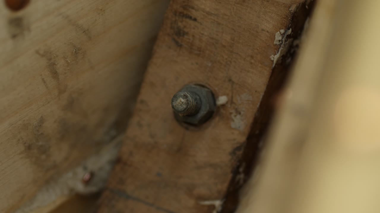 Bow stem of wooden boat secured in place with bolt