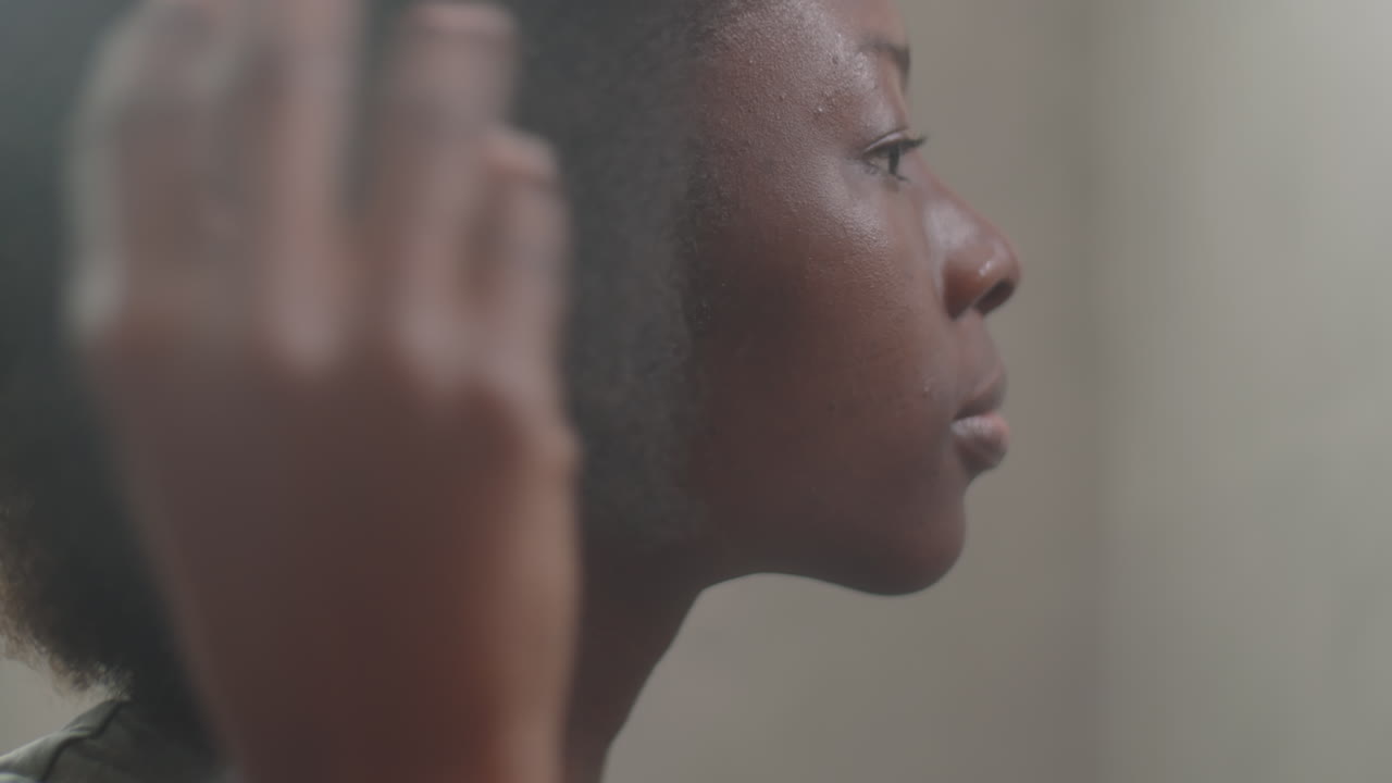 African American Woman Combing Hair