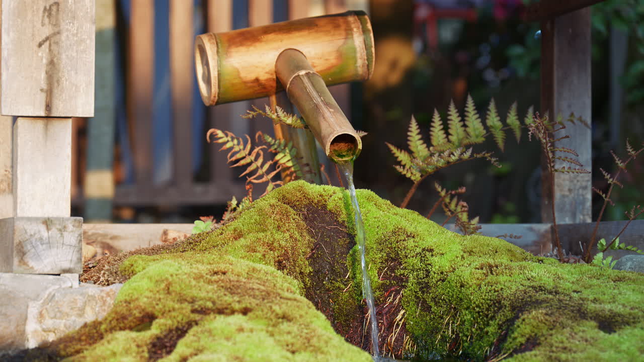 Water pouring through a fountain at the Yasaka shrine at sunset in Kyoto, Japan