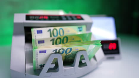 counting euro banknotes in the cash calculating machine. close up. banking concept.