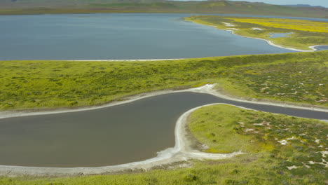 Soda-Lake-Carrizo-Plains-Californian-wet-humid-landscape,-aerial-drone-fly-above-geographical-formations-in-America