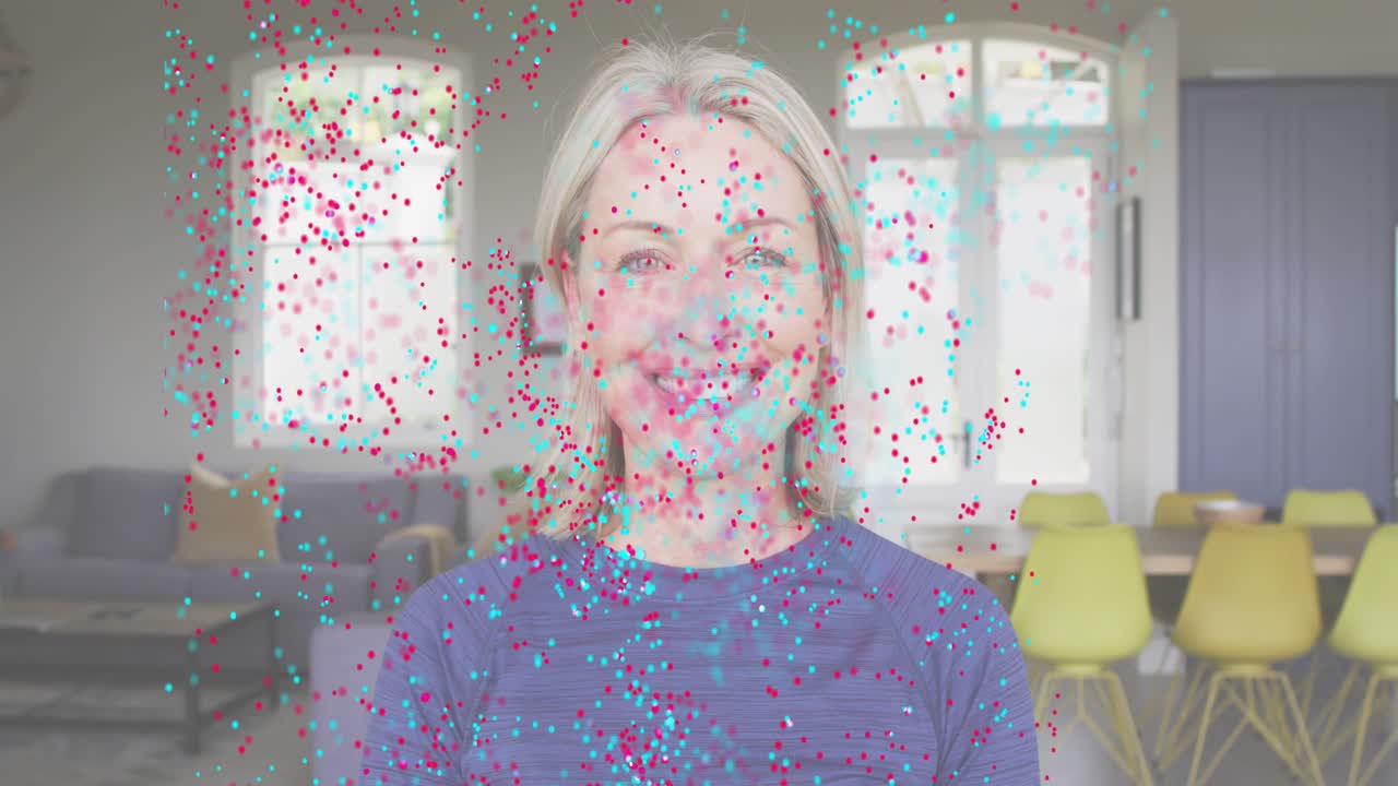 Mature woman sparking pink cyan shapes turning into red teal particles revealing smile in design ad