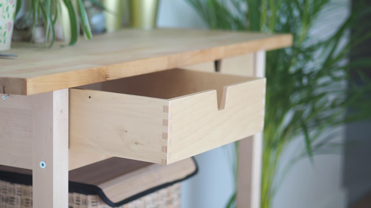 Wooden Desk with Open Drawer and Plants