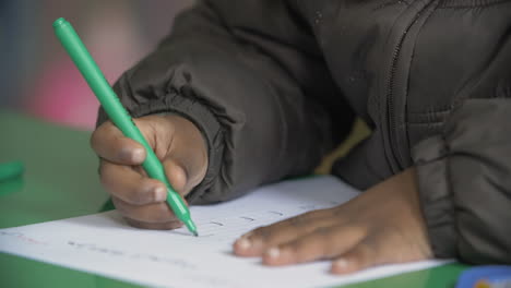 a kid writing arabic letters