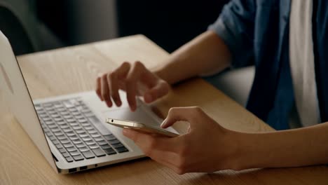 man using mobile phone and laptop at home 4k