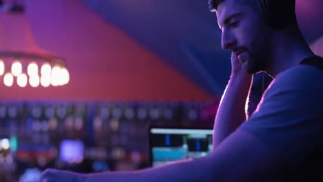 composition of caucasian male dj playing at disco