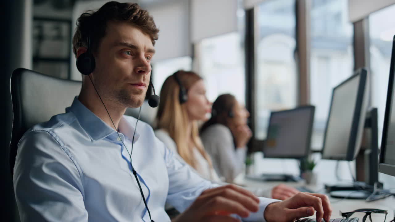 Call center team working in office. Friendly operators talk consulting clients