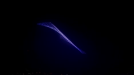 Beautiful-abstract-images-created-by-flying-drones-on-event-show-at-dark-sky,-new-technology