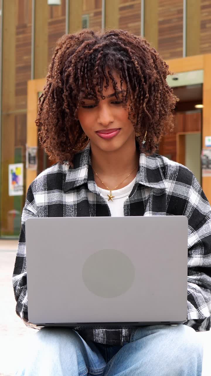 Young woman with laptop outdoors