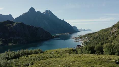 Aerial-drone-shot-of-scandinavian-landscape-with-dramatic-mountains,-ocean-and-verdant-greenery