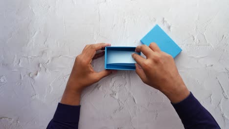 top view of person open a empty small gift box ,