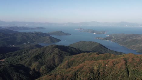 Forward-moving-drone-shot-over-the-beautiful-group-of-islands-having-a-mountainous-terrain-in-Hong-Kong-Geographical-Park-in-Sai-Kung-on-a-bright-sunny-day