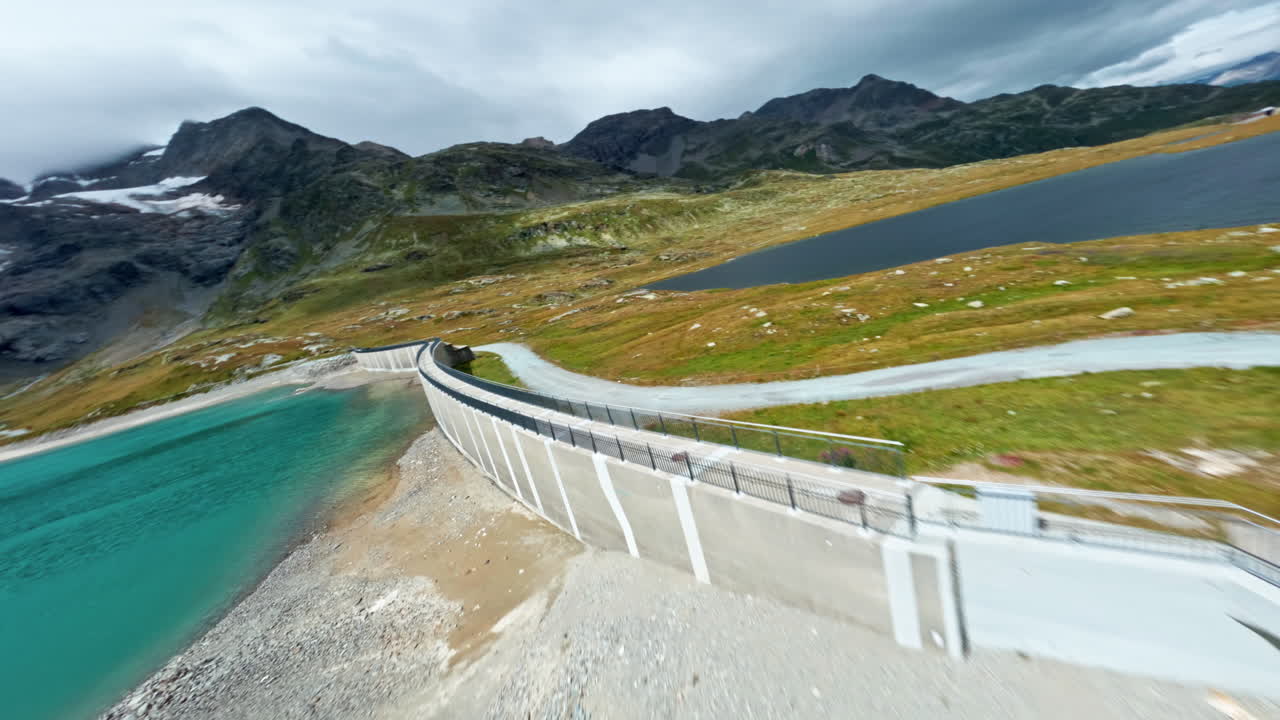 Scenic view of Bernina Pass with mountains, road, and lake, serene and scenic