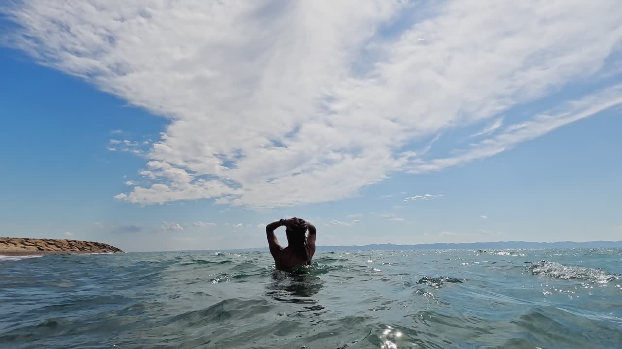 Woman in Bikini Swimming in the Ocean