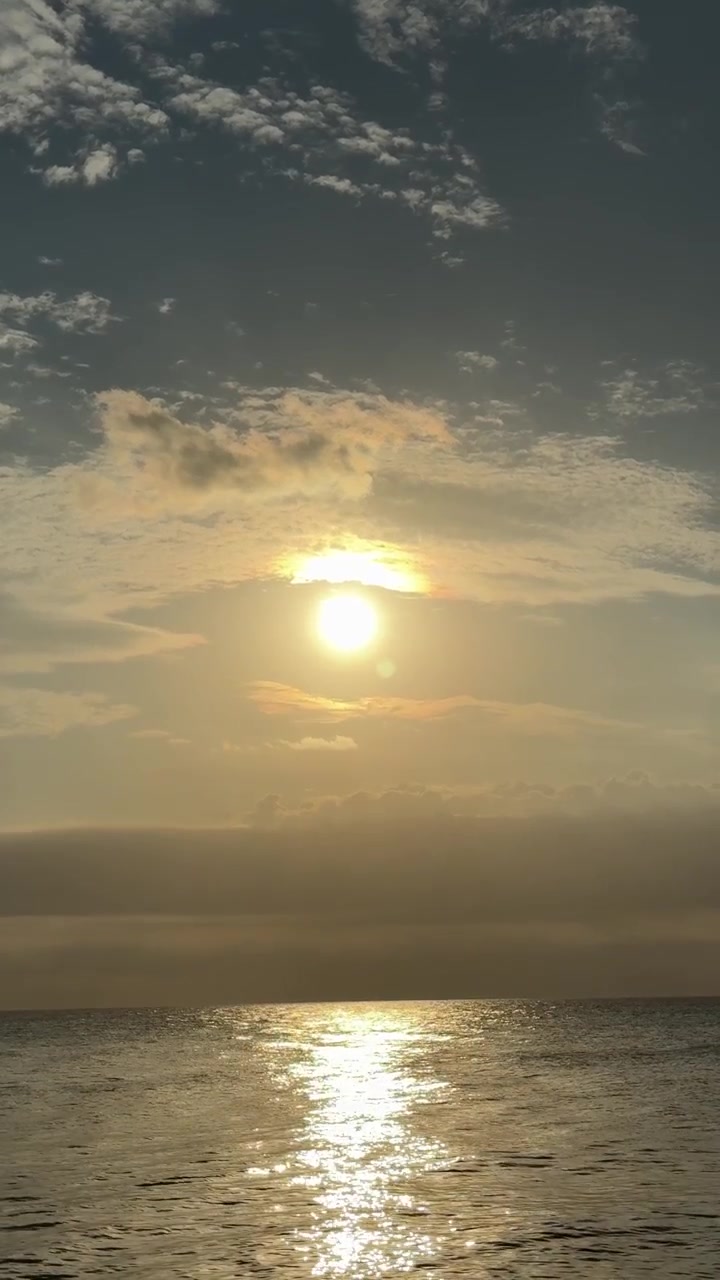 Golden Sun Reflecting on Calm Ocean Water at Sunrise