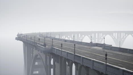 a long, empty bridge leading into the fog