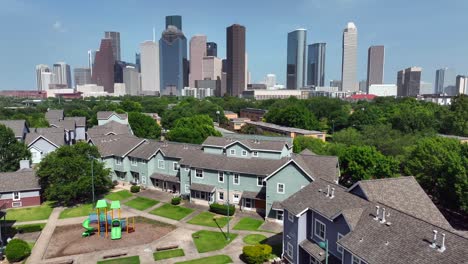 residential homes with children playground with urban city skyline in distance