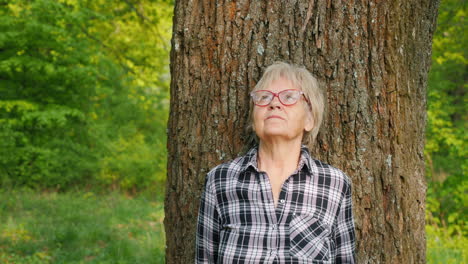 senior woman in a park looking upward